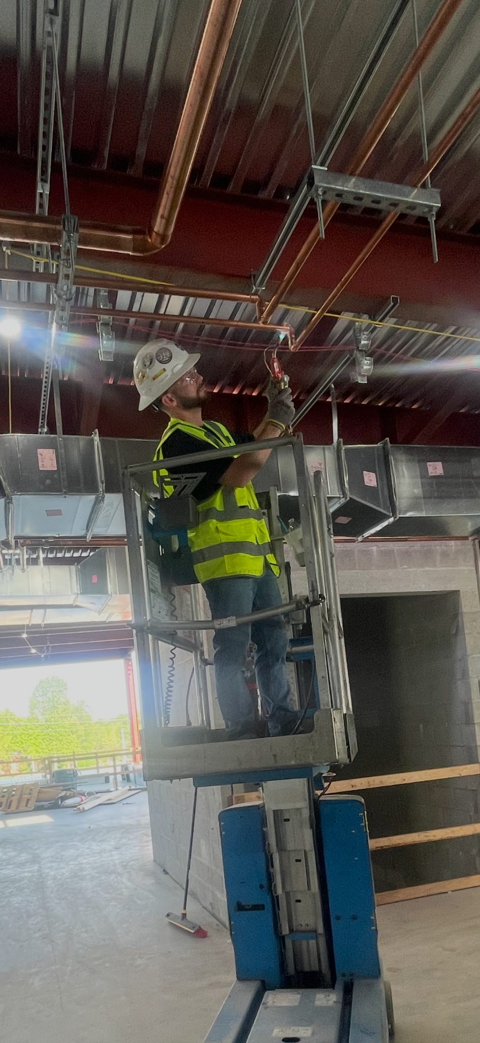 Caleb, owner of Forge Plumbing, working on commercial copper piping